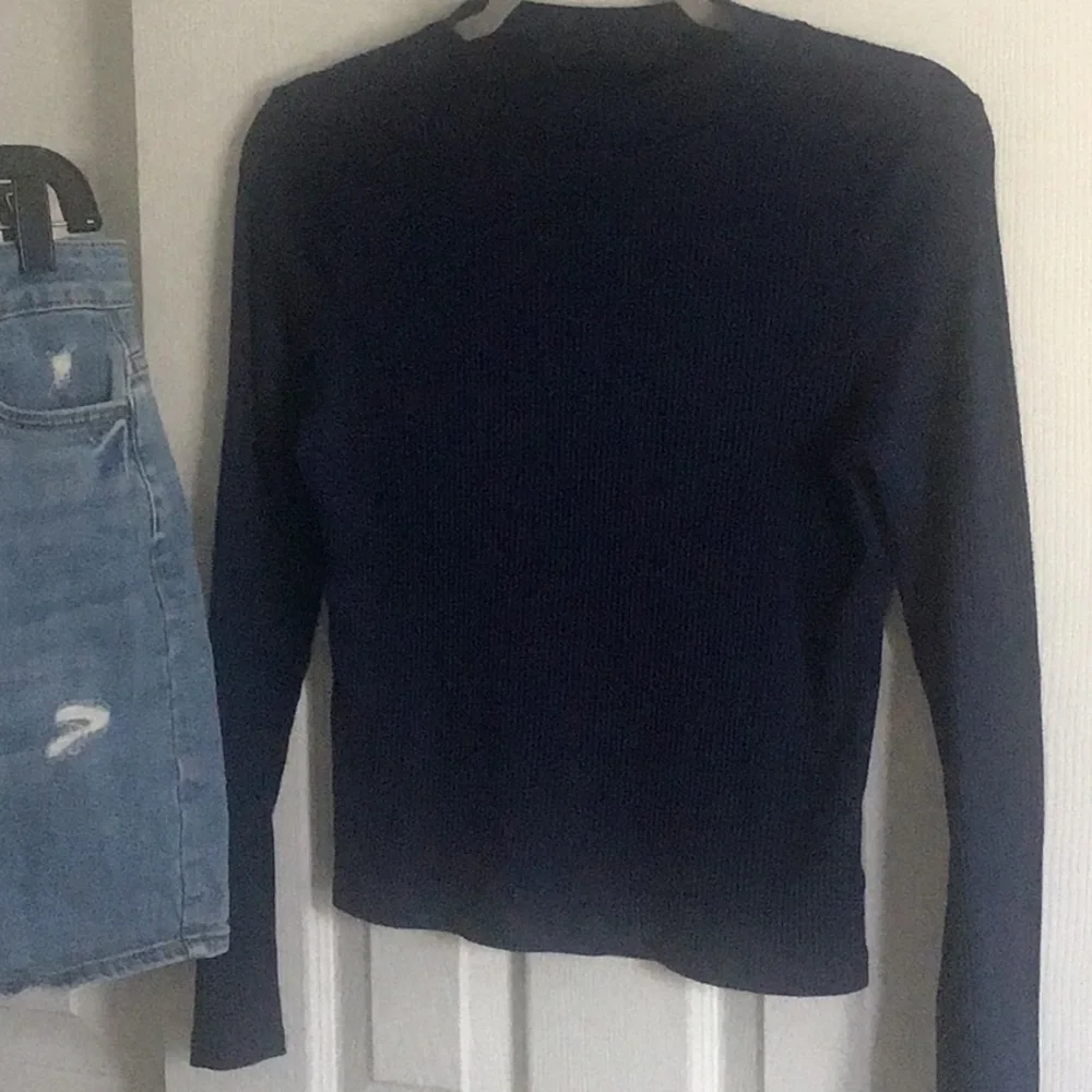 Fray features blue denim skirt with free knit top